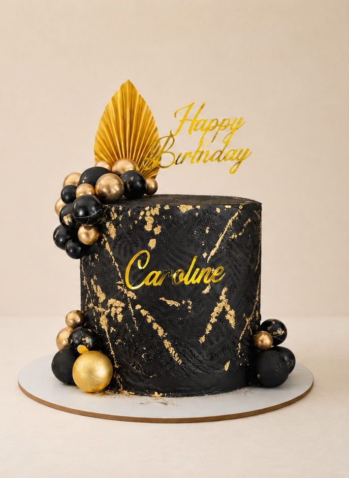 Custom black and gold birthday cake by Cakes by Teez Luxury black and gold custom birthday cake with edible gold leaf and personalised topper by Cakes by Teez in Abuja