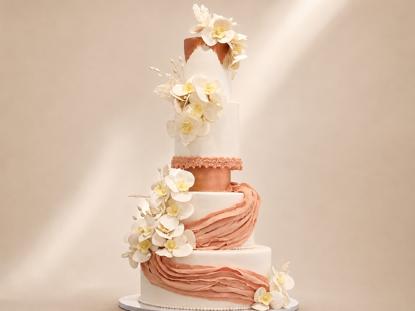Stunning four-tier blush and terracotta ruffle wedding cake with white sugar orchids and floral cascade by Cakes by Teez in Abuja