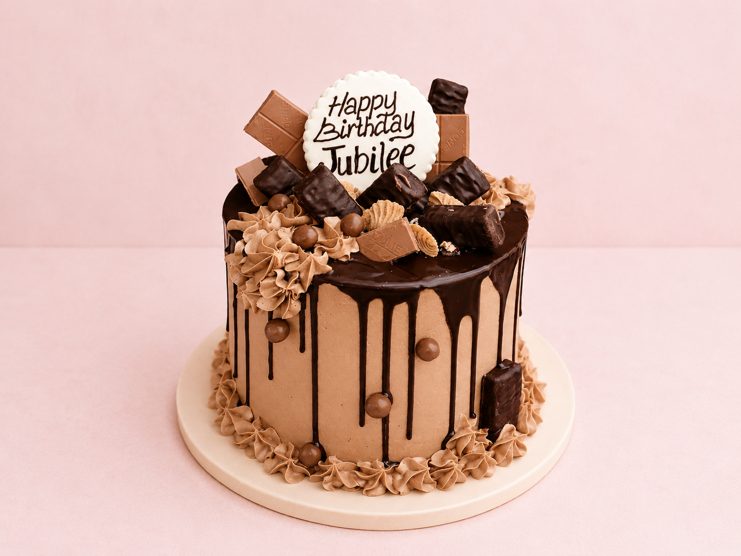 Rich chocolate drip birthday cake topped with premium chocolate bars, cookies, and buttercream swirls by Cakes by Teez in Abuja