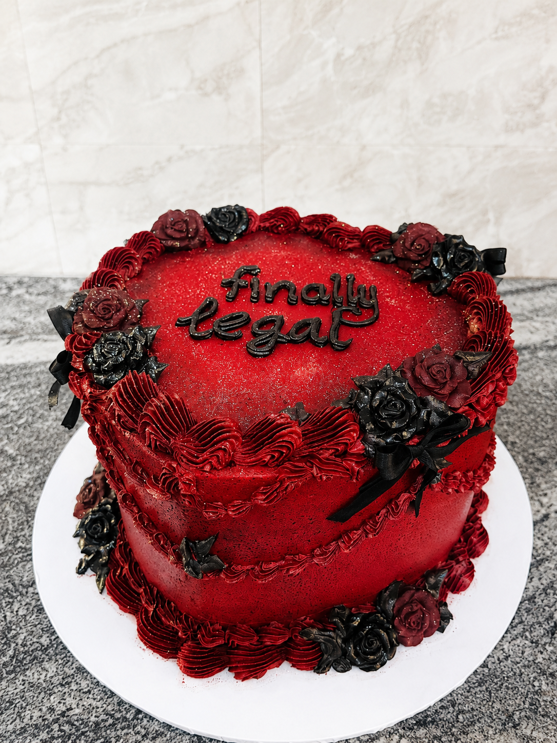 Red glitter buttercream 18th birthday cake with red and black sugar roses and black ribbon bows by Cakes by Teez in Abuja