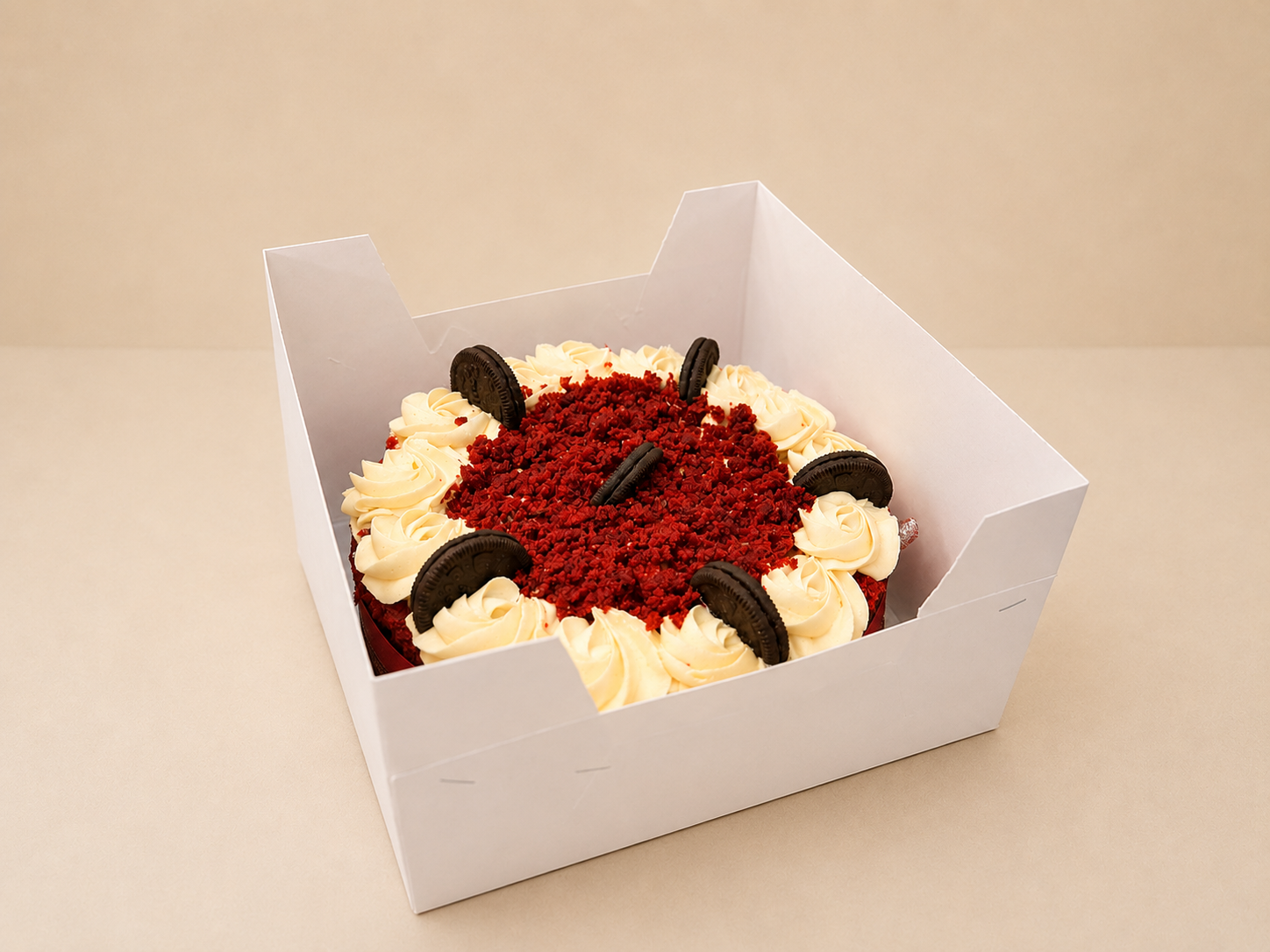Red velvet crumble cake with vanilla buttercream swirls and Oreo biscuit accents in a gift box by Cakes by Teez in Abuja