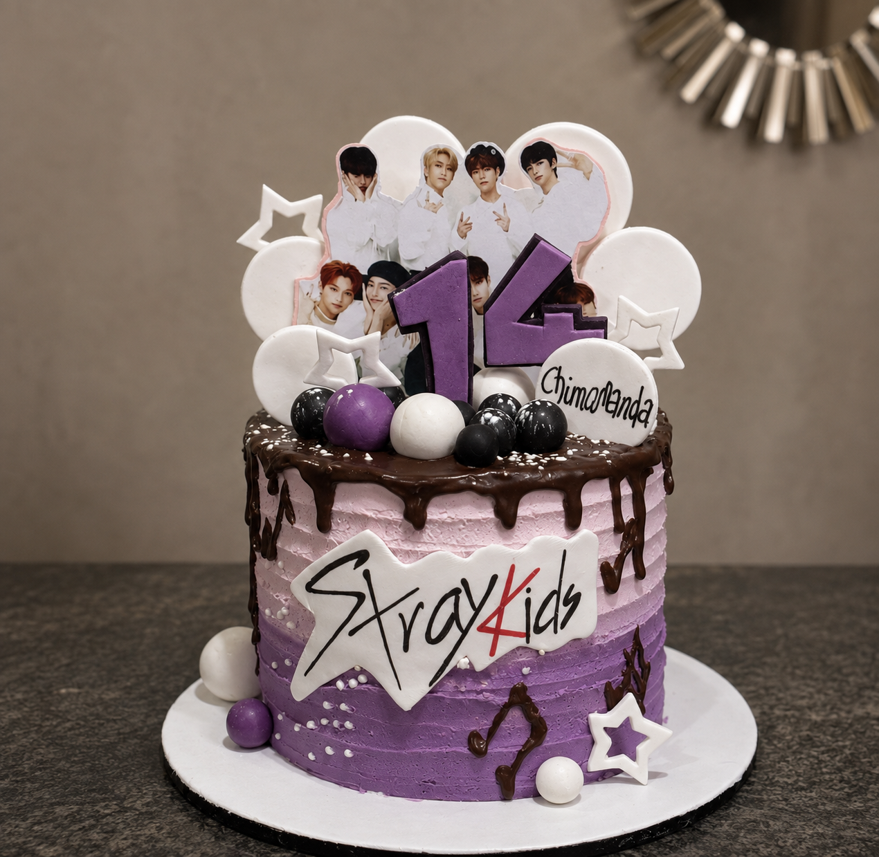Purple ombre drip birthday cake with a K-pop fandom theme, photo toppers, and a personalised name plaque by Cakes by Teez in Abuja