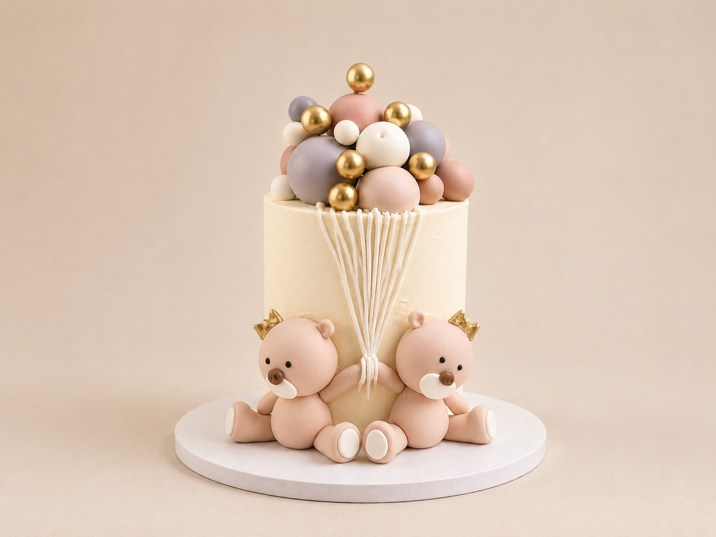 Cream buttercream luxury teddy bear birthday cake with gold spheres and fondant teddy toppers by Cakes by Teez in Abuja