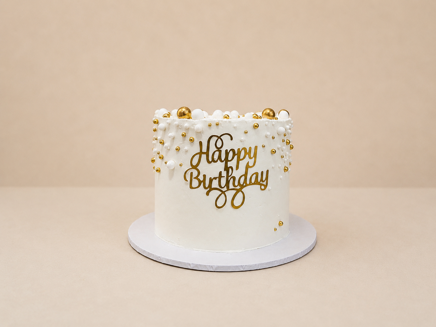 Birthday Cakes White and gold Happy Birthday buttercream cake with pearl decorations by Cakes by Teez in Abuja